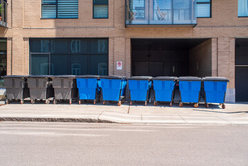 Line of plastic garbage waste disposers in the street