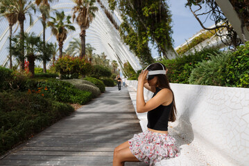 A Woman Delightfully Enjoying an Immersive Virtual Reality Experience in a Relaxing Outdoor Setting