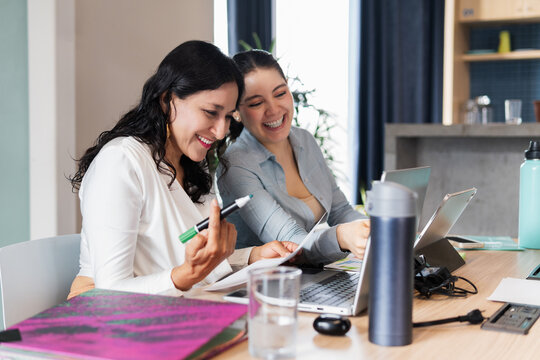 Women laughing in the office.