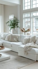 Bright and modern living room with a white couch and coffee table illuminated by natural light