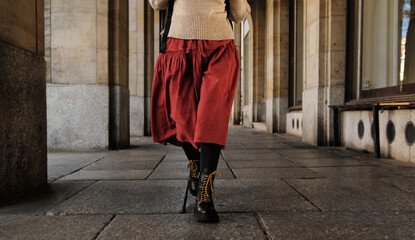 Woman In Red Skirt Walking In Autumn City