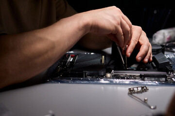 Hands Engaged in the Process of Working on Computer Hardware Installation and Upgrading