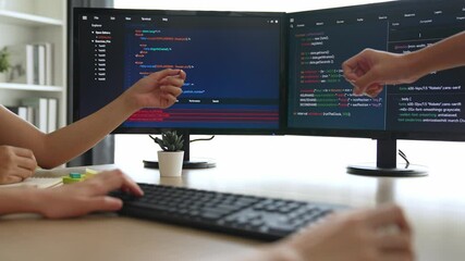 Back end software developer engineer for computer programming working together on debugging writing computing code, solving complex algorithms display on monitor in office. Burgeoning