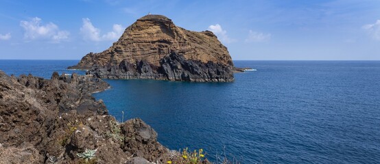 Rocks at the coast of Porto Moniz and ocean. Panorama.