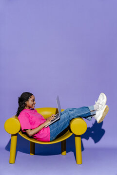 Woman with laptop, casual work day in bright environment