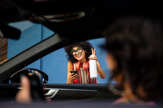 Happy Woman Waves to Driver