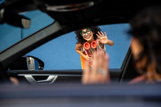 Fashionable Woman Waves to Driver