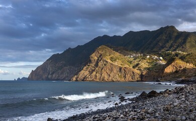 Ocean coast and beach and moutains at sunset. Port da Cruz Madeira. 