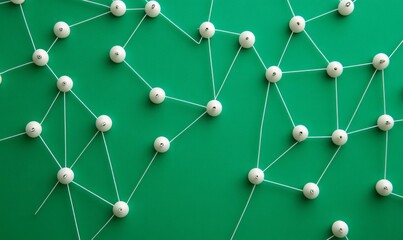 Push pins connected with white string on green background