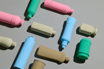 various colorful plastic bottles arranged on a grey background