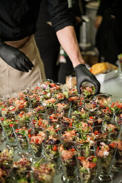 Anonymous cooker preparing catering in a restaurant