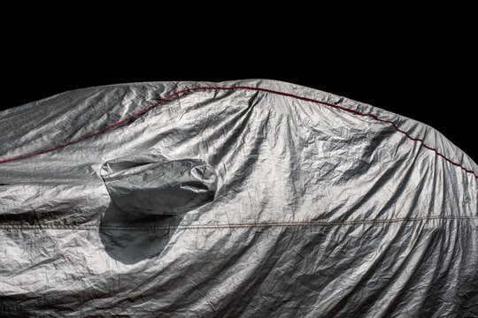 Car shrouded in a cover