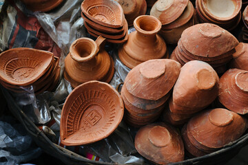 Clay pots and diyas displayed at a market stall in India