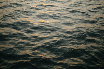 Gentle waves reflecting evening light on a tranquil water