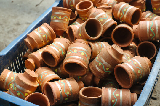 Clay pots stacked in a basket at a pottery workshop in the afternoon