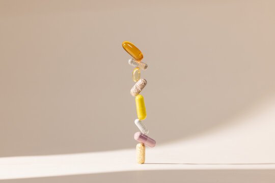 Colorful Capsules and Vitamins Stacked Vertically