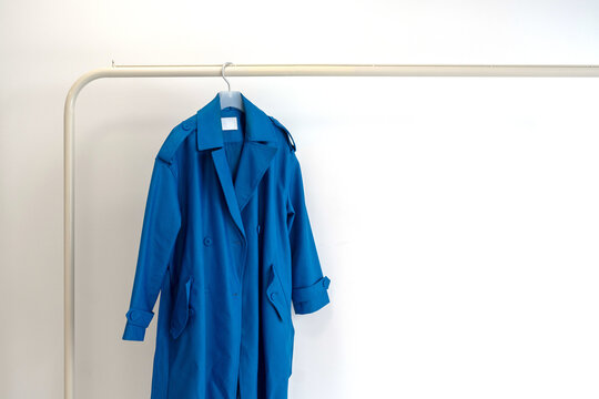 Blue Coat On Hanger With Minimalist Clothing Rack