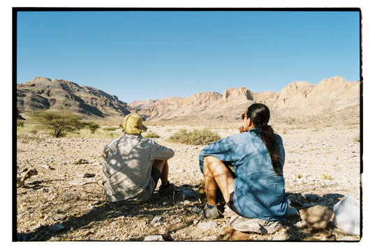 Hikers sit in shade to rest