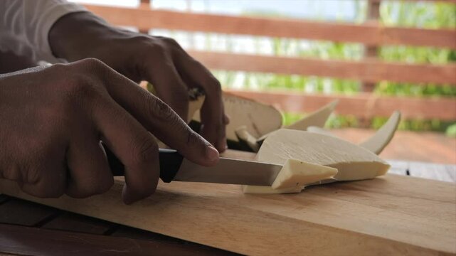 Man cutting breadfruit (Martinique)