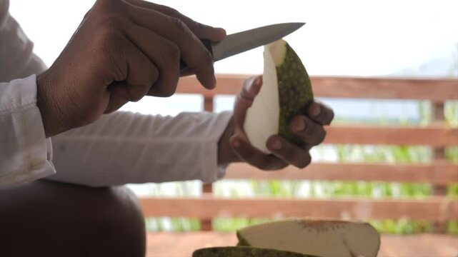 Man cutting breadfruit (Martinique)