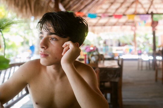Shirtless Teen Boy at table