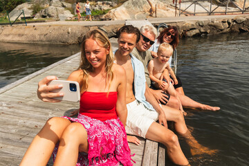Family Taking Selfie on Jetty by Ocean
