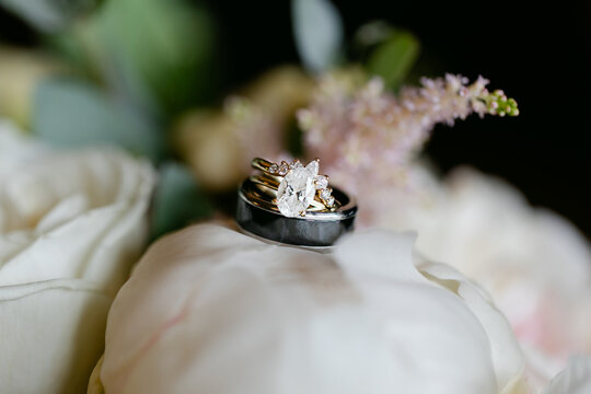 Beautiful Wedding Rings Sparkling and Sitting on Rose Bud