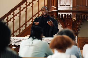 Young pastor delivering sunday sermon from the pulpit