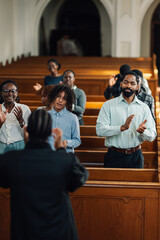 Congregation clapping along to gospel music in church