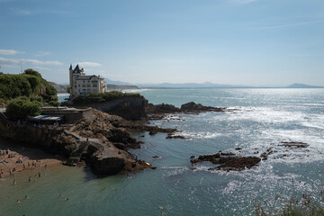 Scenic Coastal View of Biarritz with Cliffside Mansion and Rocky Shoreline