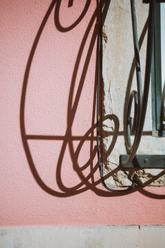 Shadow of Forged Grating on Pink Wall