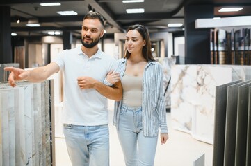 Married couple chooses ceramic tiles for kitchen or bath at a hardware store