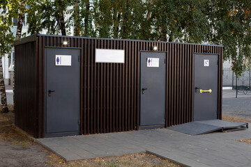 Public toilet for people in park, taking care of natural needs of people, accessible modern toilet...