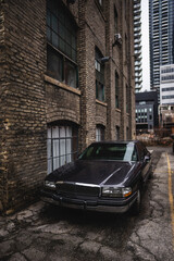 vintage 80s American car at street of New York city by brick building