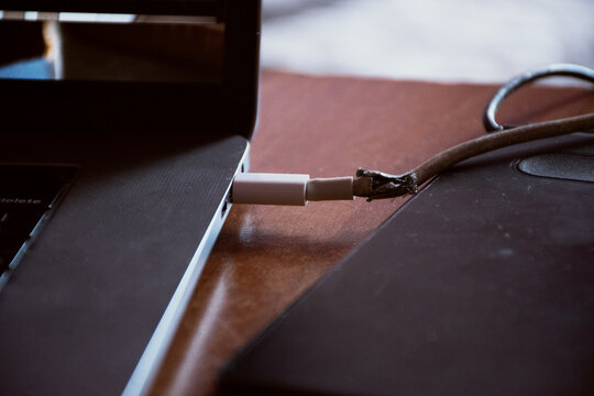 Damaged laptop charger with editing tablet