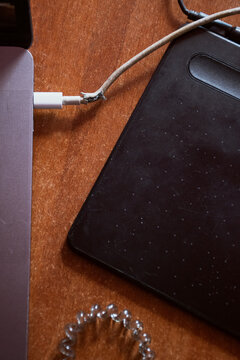 Damaged laptop charger with editing tablet