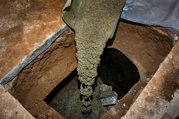 Concrete poured through cut in an old buried oil tank under garage concrete floor. Tank prior...