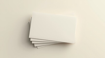 Close-up studio shot of a stack of three blank, off-white business cards