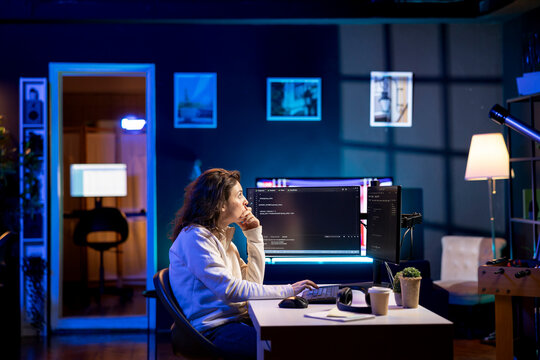 System administrator doing software debugging on PC at home, checking broken lines of code displayed on AR hologram. IT professional in living room fixing coding problems using augmented reality