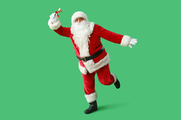 Dancing Santa Claus with Christmas bell on green background