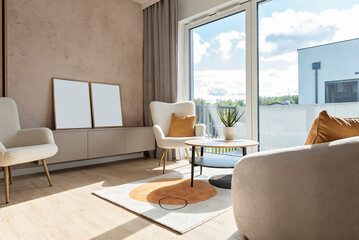 Modern living room with sofa, window and armchair with mustard pillow. Luxurious interior with wall with empty picture frame with mock up.. Real estate. New apartment.
