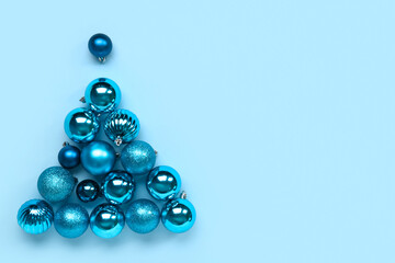 Christmas balls in shape of tree on blue background