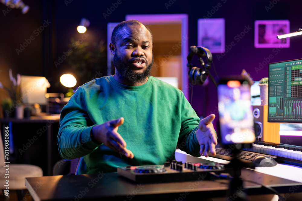Leinwandbilder sound engineer explaining all controls on a mixing console during online teaching lesson on a video,