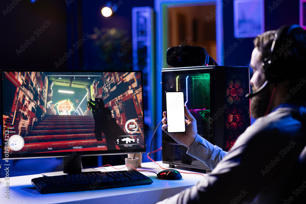 Poster man in dimly lit apartment watching tutorial on how to finish videogame on isolated screen smartphon