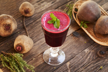 Red beet juice in a glass cup on a table