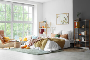 Interior of bedroom with shelf units and pumpkins