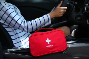 Driver with first aid kit in car