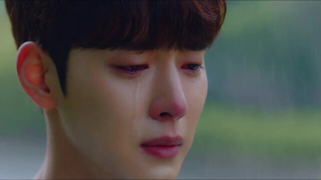 Heartbreak: A Close-Up of a Young asian Man's Face Revealing Sadness and Reflection
