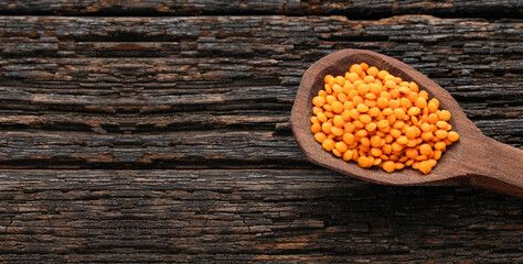 Spoon with raw red lentils - Lens culinaris.