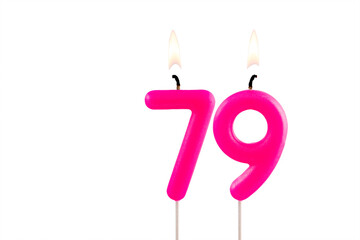 Pink number 79 birthday candle lit on white background